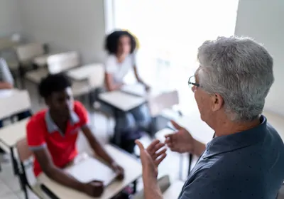 teacher in front of a classroom teacher in front of a classroom
